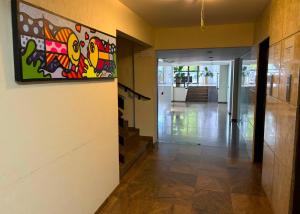 a hallway with a painting on the wall at Brisamar Suite Hotel in Florianópolis