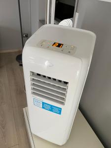 a white air conditioner sitting in a room at "La Bella della Cappuccina" Casa con Parcheggio Interno Gratuito in Domodossola