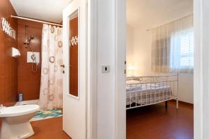 a bathroom with a toilet and a sink and a shower at Carasau 200m from the Beach - Garden - BBQ - Wi-Fi - Parking - Pet Friendly in Budoni