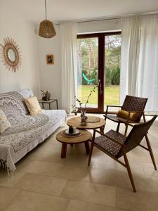 a living room with a couch and a table at Bursztynowa 16 Hel in Hel