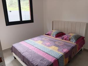 a small bed in a room with a window at Villa Aloa Private pool in Les Abymes +12 photos