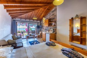 a bedroom with a large bed and a living room at Liman Pansiyon Palamutbükü in Datca