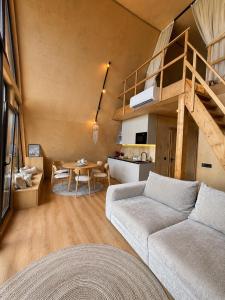 a living room with a couch and a loft at Dilok Hills in Mykulychyn