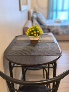 a wooden table with a plant on top of it at New OneHeart Avida Riala T5 Condo in Cebu City +3 photos