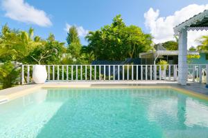 a swimming pool with a white fence at Villa Antema in Riambel