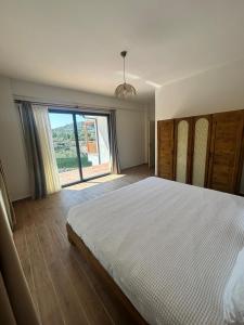 a bedroom with a large bed and a large window at Villa Keyf Göcek in Fethiye +15 photos