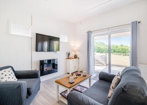 a living room with two couches and a fireplace at Henfields Country Retreat in Cannington
