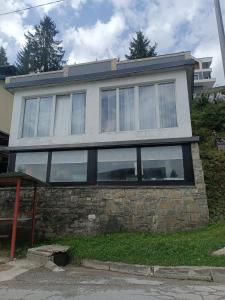 a house on top of a stone wall at Mountain Apartment Vlašić Babanovac in Vlasic