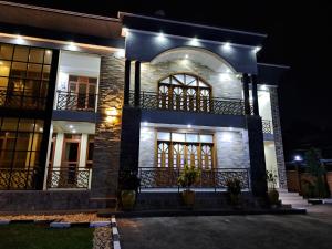 a house at night with lights on it at Royce's Apartment in Kigali