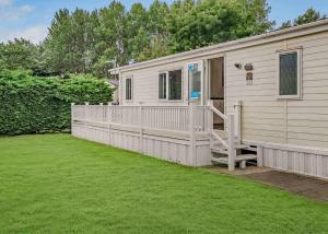 a small house with a porch and a yard at Cherry Tree in Belton