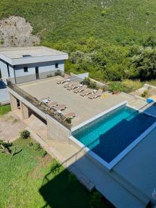 an overhead view of a swimming pool with lounge chairs at Vila Lavandel in Bečići