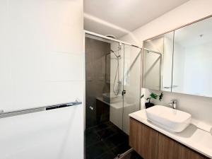 a white bathroom with a sink and a shower at C02-Diamond Loft 2BR apart, elevated living style in Ginninderra +27 photos