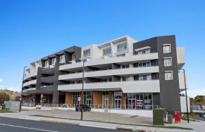 an apartment building on the corner of a street at C02-Diamond Loft 2BR apart, elevated living style in Ginninderra