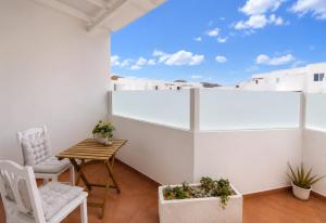 a balcony with a table and chairs and a view at MiVida in San Bartolomé
