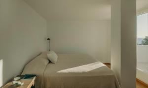 a bedroom with a bed and a window at Damma Villa in Kamari +29 photos