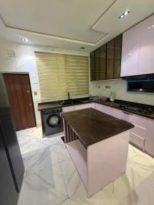 a kitchen with a counter and a stove in it at Xclusive Luxury Apt in Mopo Onijebu +11 photos