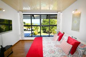 a room with a red bed and a large window at Villa Antema in Riambel +43 photos