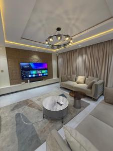 a living room with a couch and a tv at Xclusive Luxury Apt in Mopo Onijebu