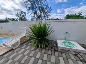 a patio with a chair and a potted plant at Vanz Villa in Mont Choisy