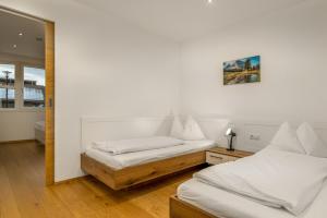 a bedroom with two beds and a mirror at Residence Diana Apartment 402 in Terento
