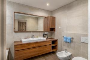 a bathroom with a sink and a toilet at Residence Diana Apartment 402 in Terento +22 photos