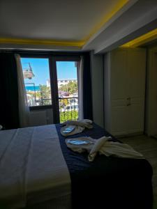 a bedroom with a bed with towels on it at Ada Marin Hotel in Urla +33 photos