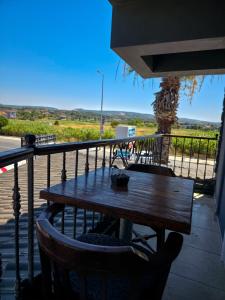 a wooden table on a balcony with a view at Ada Marin Hotel in Urla