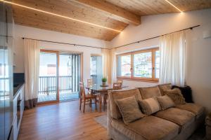 a living room with a couch and a table at Ciasa Verena in Corvara in Badia