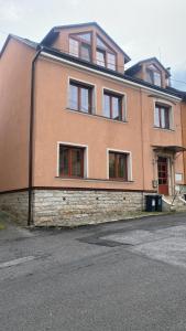 a large brick building with windows on a street at Apartmán v Liliové in Jablonec nad Nisou