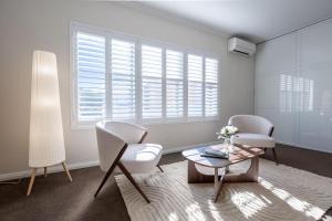 a living room with two chairs and a coffee table at Family Friendly, Stylish Floreat, Pool in Perth
