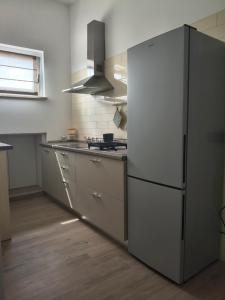 a kitchen with a large white refrigerator in it at Agriturismo L'Olivastro in Pollutri +37 photos