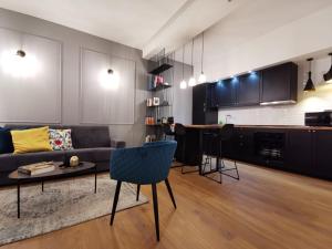 a living room with a couch and a table at FLORENTIN Downtown Design Apt in Bergamo