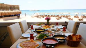 a table with food and a view of the beach at Mad Sea Beach Hotel in Şile