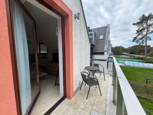 a patio with two chairs and a table on a balcony at Bursztynowa 16 Hel in Hel
