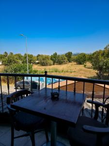 a table and chairs on a balcony with a view at Ada Marin Hotel in Urla