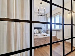 a bedroom with a bed through a window at FLORENTIN Downtown Design Apt in Bergamo