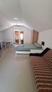 a bedroom with two beds and a table and chairs at Coco free parking in Pržno