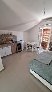 a kitchen and a living room with a bed and a table at Coco free parking in Pržno