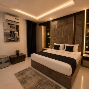a bedroom with a large bed in a room at Palazzo Apartments in Ikeja