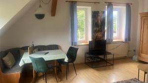 a small living room with a table and chairs at Ferienhof Weber Nieratz in Wangen im Allgäu