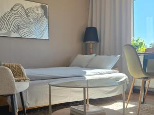 a living room with a couch and a glass table at PAE korter Kärdlas in Kärdla