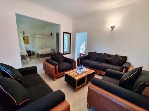 a living room with couches and a coffee table at Tan-Swiss Inn in Mikumi