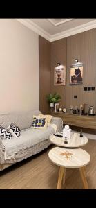 a living room with a couch and a table at Ksa3 in Hail +2 photos