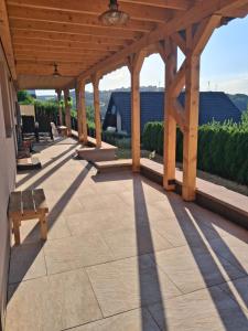 a wooden pergola with a bench on a patio at Ferienwohnung Moin Eifel in Schleiden