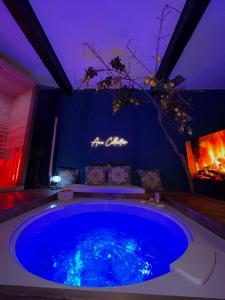 a large blue tub in a room with a fireplace at Ama Collection Esclusive Spa Ariosto in Ferrara