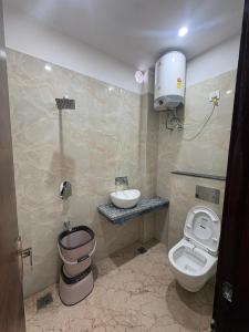 a bathroom with a toilet and a sink at Hotel U V 2 mins from golden temple in Amritsar +14 photos