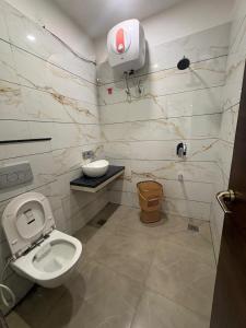 a bathroom with a toilet and a sink and a shower at Hotel U V 2 mins from golden temple in Amritsar