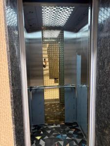 a shower stall with a mirror in a bathroom at Hotel U V 2 mins from golden temple in Amritsar