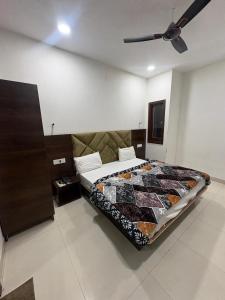 a bedroom with a bed and a ceiling fan at Hotel U V 2 mins from golden temple in Amritsar