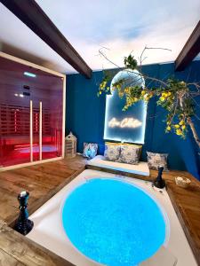 a bathroom with a sink and a large blue pool at Ama Collection Esclusive Spa Ariosto in Ferrara